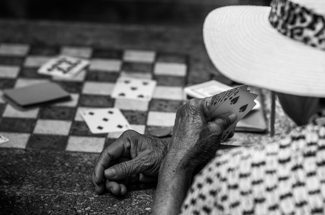 elderly people playing cards