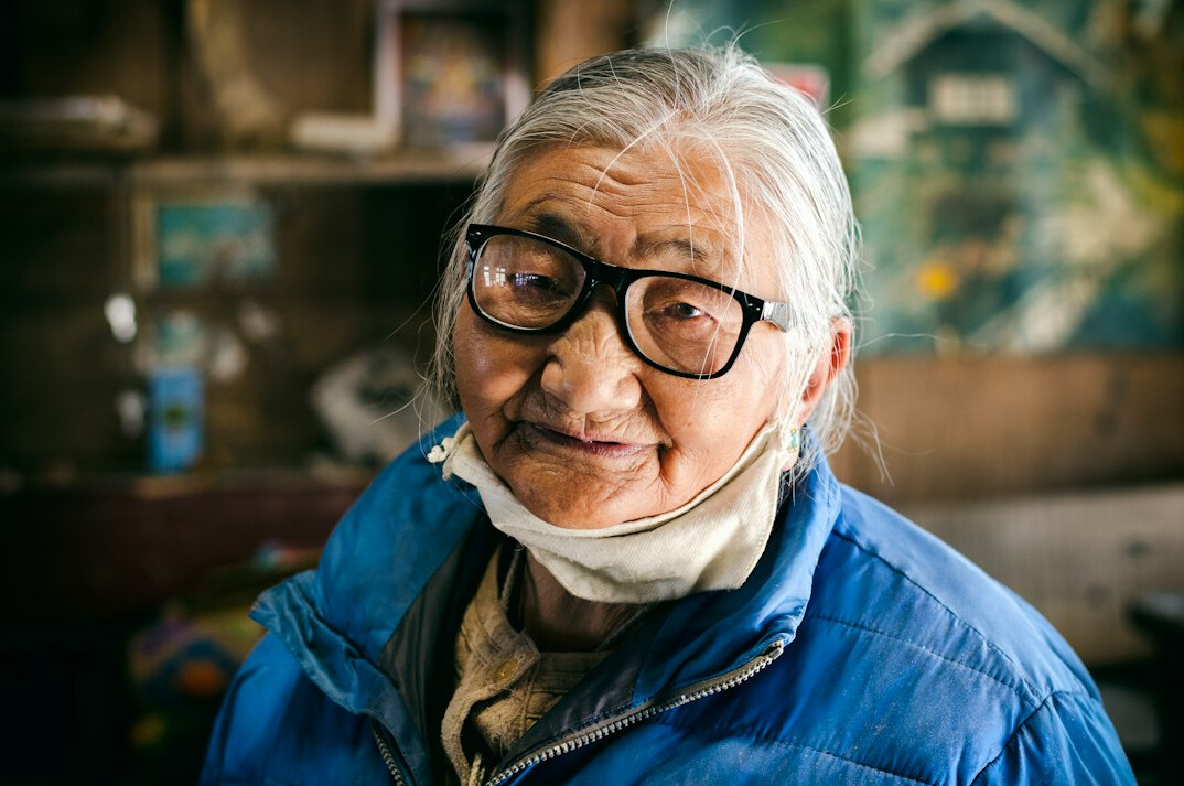 Portrait of a cheerful elderly woman wearing glasses